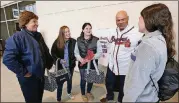 ?? CURTIS COMPTON / CCOMPTON@AJC.COM ?? Dr. Mary Boden (from left) and her triplet daughters Stephanie, Allison and Lauren shared a laugh while they met former Braves player Chris Chambliss at the Braves Women’s Baseball Clinic at SunTrust Park before the Braves played the Yankees in a...