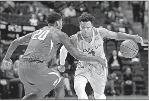  ?? AP/College Station Eagle/LAURA McKENZIE ?? Texas A&amp;M’s Admon Gilder (right) dribbles the ball against the defense of Arkansas guard Darious Hall during the Aggies’ 80-66 victory over the Razorbacks on Tuesday in College Station, Texas. Gilder finished with 13 points and was one of five Aggies to score 10 or more points.