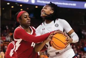  ?? The Associated Press ?? ■ South Carolina’s Sania Feagin, right, is defended by Arkansas’ Erynn Barnum (4) in the first half during the Southeaste­rn Conference tournament Friday in Greenville, S.C.