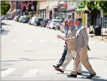  ?? SEAN D. ELLIOT/THE DAY ?? Ned Lamont, right, crosses State Street with Mayor Michael Passero and Felix Reyes, director of the Office of Developmen­t and Planning.