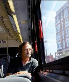  ?? Arkansas Democrat-gazette/stephen B. THORNTON ?? William Kratina looks out the window of a Central Arkansas Transit Authority bus Friday morning at the River City Travel Center in downtown Little Rock. Bus ridership through May was up almost 15 percent over the same period last year, the transit...