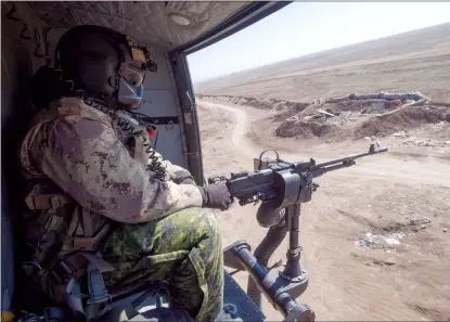  ?? CP FILE PHOTO ?? A Canadian Forces door gunner keeps watch as his Griffon helicopter goes on a mission in February 2017 in northern Iraq. A former foreign policy adviser to the Canadian government says there could be concerns for the safety of Canadian Forces following the killing of a top Iranian general.