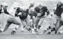  ?? LJG THE ASSOCIATED PRESS ?? In this undated file photo, Packers’ Jerry Kramer (64) blocks for Paul Hornung (5) during a football game in Green Bay, Wisc. Hornung died Friday at the age of 84.