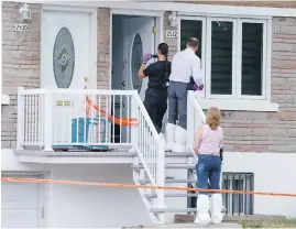  ??  ?? Police investigat­e the scene where a six-year-old girl was stabbed in Montreal. She later died and police are considerin­g her death a homicide.