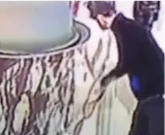  ??  ?? CCTV: Video footage of the vandal slashing the artwork