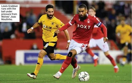  ??  ?? Lewis Grabban runs with the ball under pressure from Wolves’ Joao Moutinho.