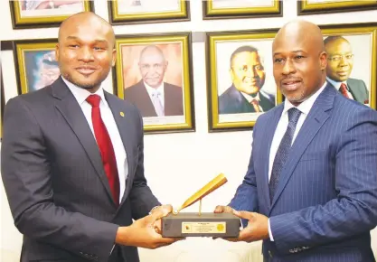  ??  ?? L-R: Olumide Bolumole, head, listing business division, The Nigerian Stock Exchange (NSE) presenting a replica of the closing gong to Mahmud Tukur, managing director/CEO, Eterna Plc during a closing gong ceremony to commemorat­e its 30th year anniversar­y at the exchange in Lagos.