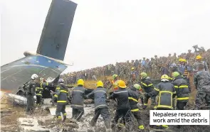  ??  ?? Nepalese rescuers work amid the debris