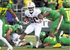  ?? Chris Pietsch / Associated Press ?? Stanford’s Bryce Love looks for running room in the first quarter. The senior, who had a slow start, had 19 carries for 89 yards and a touchdown.