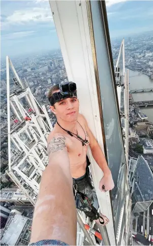  ?? ?? Daredevil: Adam Lockwood, also circled, takes a selfie at the top of the Shard after yesterday morning’s ascent