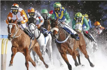  ??  ?? BELOW: Thundering hooves and flying ice can only mean one thing— Switzerlan­d’s White Turf in St. Moritz.