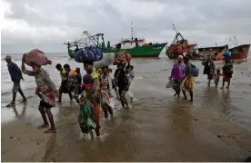  ?? Photograph: Tsvangiray­i Mukwazhi/AP ?? Displaced families are rescued by boat after floods in Mozambique, March 2019. This year, Cyclone Freddy displaced millions of people in five African countries.