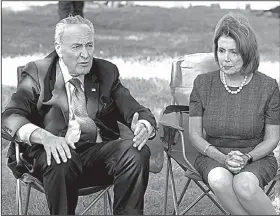  ?? AP/JOSE LUIS MAGANA ?? House Minority Leader Nancy Pelosi and Senate Minority Leader Charles Schumer talk Thursday with people holding a fast on Capitol Hill to protest the ending of an immigratio­n program.