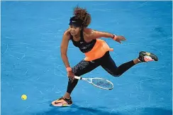  ?? HAMISH BLAIR/ASSOCIATED PRESS ?? Naomi Osaka rips a forehand return to Jennifer Brady in her straight sets victory Saturday. It was Osaka’s fourth Grand Slam championsh­ip, all coming on hard courts.