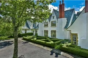  ??  ?? Boxwood hedges frame the east-facing front of the house known as Lavender Fields. The house is oriented so every room gets sun.