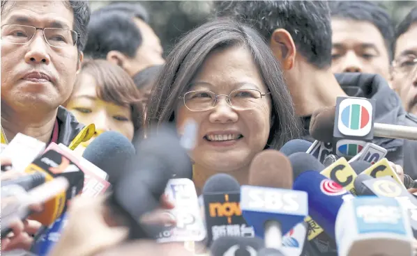  ??  ?? SWEEPING VICTORY: Taiwan’s Democratic Progressiv­e Party leader and presidenti­al candidate Tsai Ing-wen talks to the media after casting her ballot in the general elections in New Taipei yesterday.