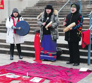  ?? NICK PROCAYLO/PNG ?? From left, Lenlen Castro, Jody Leon and Ida Manuel protest outside Curtis Wayne Sagmoen’s assault trial in Port Coquitlam on Monday.