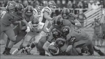  ??  ?? A host of Loramie defenders swarms the Vikings ball carrier on Sept. 11. Photo by David Pence