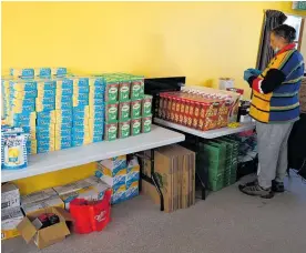  ?? ?? On Mondays and Tuesdays, volunteers from the community and Legacy Church come in to help sort through the donated grocery items.