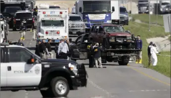  ??  ?? Officials remove a car of the suspect in a series of bombing attacks in Austin from the scene where he blew himself up as authoritie­s closed in Wednesday in Round Rock, Texas. AP PHOTO/ERIC GAY