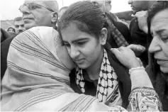  ??  ?? Khatib being greeted by relatives after her release from jail, in the West Bank Palestinia­n village of Tulkarem. — AFP photo