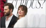  ??  ?? Jamie Dornan and Dakota Johnson attend a special fan screening of “Fifty Shades of Grey” at the Ziegfeld Theatre on Friday in New York City.