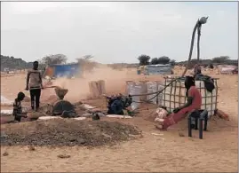  ?? BABA AHMED/AP ?? Gold panners break stones in Kidal, Mali, amid a gold rush in northern Mali in an area where al-Qaida-linked militants operate. A coalition of rebels oversees the gold panning.