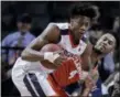  ?? JULIE JACOBSON — THE ASSOCIATED PRESS FILE ?? Virginia guard De’Andre Hunter, left, pulls down rebound during semifinals of the Atlantic Coast Conference tournament in New York.