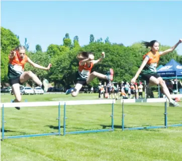  ??  ?? Chloe Marriott, Emily Rhodes and Tanya Pont fly over the hurdles during the multi event meet at Warragul Little Athletics Centre.