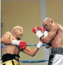  ?? Picture: MARK ANDREWS ?? TAKE THAT: Azinga Fuzile hits his opponent Malcolm Klassen with a left at the Orient Theatre on Sunday. Klassen eventually quit in the fourth round.