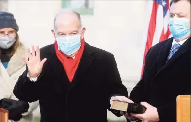  ?? Ned Gerard / Hearst Connecticu­t Media ?? Martin Looney, D-New Haven, is sworn in as Senate President Pro Tempore during the of the start the legislativ­e session held outside at the State Capitol in Hartford on Jan. 6.