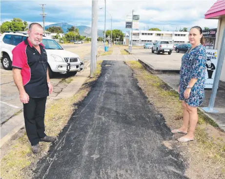  ?? Picture: SCOTT RADFORD- CHISHOLM ?? ANGERED: Geoff Gallon of Gallon's Automotive and Peta Horton of Marion's Sewing Room look on with dismay at the new footpath on Mooney St, Gulliver, which has been criticised for not being up to standard.