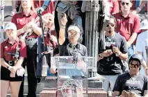  ?? TRACY GLANTZ tglantz@thestate.com ?? University of South Carolina head coach Dawn Staley acknowledg­es the fans after a championsh­ip parade through downtown Columbia and a ceremony at the South Carolina State House on April 14, 2024.