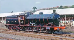  ?? JOHN HUNT ?? The ‘Q6’ runs past the football stadium-like grandstand­s at the August 1975 Shildon cavalcade to mark 150 years of the Stockton & Darlington Railway. The locomotive will revert to a different NER livery in May (SR480).