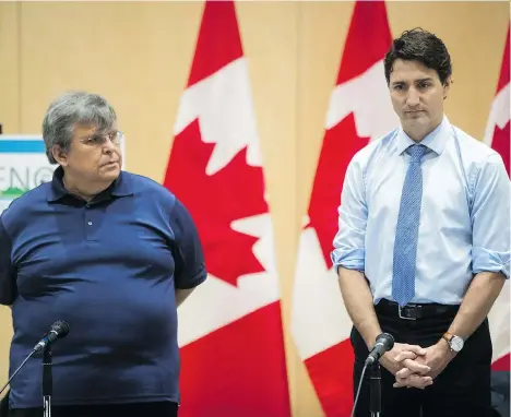  ?? DARRYL DYCK/THE CANADIAN PRESS ?? Cheam First Nation Chief Ernie Crey and Prime Minister Justin Trudeau pray before a discussion with the Indigenous Advisory and Monitoring Committee in Rosedale on Tuesday. Crey says his community would consider buying a stake in the Trans Mountain...