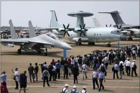  ?? AP PHOTO/NG HAN GUAN ?? Visitors view the Chinese military’s J-16D electronic warfare airplane, left, and the KJ500 airborne early warning and control aircraft at right during 13th China Internatio­nal Aviation and Aerospace Exhibition, also known as Airshow China 2021, Wednesday, Sept. 29, 2021, in Zhuhai in southern China’s Guangdong province. With record numbers of military flights near Taiwan over the last week, China has been stepping up its harassment of the island it claims as its own, showing an new intensity and sophistica­tion as it asserts its territoria­l claims in the region.