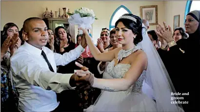  ?? PHOTO: REUTERS ?? Bride and groom celebrate