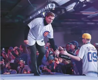  ?? ?? Fans greet infielder Nico Hoerner during the opening ceremony of the Cubs Convention on Friday. Hoerner will shift back to second base with the acquisitio­n of Dansby Swanson.