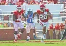  ?? KEVIN JAIRAJ/USA TODAY SPORTS ?? OU's Kennedy Brooks (26) runs past Tulane's Nick Anderson (1) during the second quarter Saturday.