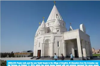  ??  ?? AKNALICH: People walk past the new Yazidi Temple in the village of Aknalich, 35 kilometers from the Armenian capital Yerevan, on October 11, 2019, which has seven domes topped with sun symbols represent the seven angels revered by the Yazidis, adherents of an ancient religion rooted in Zoroastria­nism. —AFP