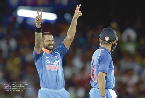  ?? — AFP ?? India’s Shikhar Dhawan celebrates scoring a century during the first ODI against Sri Lanka at the Rangiri Dambulla Internatio­nal Cricket Stadium in Dambulla on Sunday.