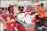  ??  ?? A customer wears a mask as she waits to get a receipt at a register in a Target store in Vernon Hills, Illinois. Retail sales fell in May, dragged down by a decline in auto sales, likely due to fewer cars being made amid a pandemic-related shortage of chips. (AP)