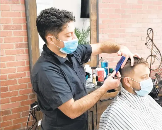  ?? RYAN KNELLER/THE MORNING CALL ?? Tristan’s Barbershop owner Tristan Burke cuts the hair of John Herman at his newly opened barbershop at 411 W. Broad St. in Bethlehem. The shop offers men’s and women’s haircuts, fades, straight-razor cuts, beard trims, shaves, men’s hair coloring and facial hair grooming.