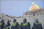  ?? JOHN MINCHILLO — THE ASSOCIATED PRESS ?? Police form a line after violent rioters stormed the Capitol in Washington on Jan. 6.