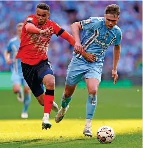  ?? ?? Luton’s Carlton Morris and City’s Callum Doyle (right) battle for the ball