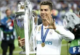  ?? PAVEL GOLOVKIN — THE ASSOCIATED PRESS ?? In this Saturday file photo Real Madrid’s Cristiano Ronaldo celebrates with the trophy after winning the Champions League Final soccer match between Real Madrid and Liverpool at the Olimpiyski­y Stadium in Kiev, Ukraine.