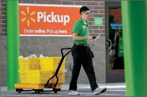  ?? NWA Democrat-Gazette/DAVID GOTTSCHALK ?? Carlos Calderon delivers groceries to a customer in May at a Bentonvill­e Wal-Mart. The retailer recently opened the online grocery pickup option for consumers who use Electronic­s Benefits Transfer cards at five locations .