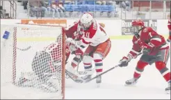  ?? Phoebe Sheehan / Special to the Times Union ?? Ottoville Leppanen, center, scores a goal during the first period against St. Lawrence to tie the game 1-1 on Saturday in Troy.