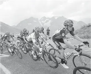  ?? CHRISTOPHE ENA/AP ?? France’s Julian Alaphilipp­e, wearing the overall leader’s yellow jersey, climbs the Galibier pass during the 18th stage of the Tour de France Thursday.