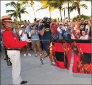  ?? (AP/Florida Keys News Bureau/Andy Newman) ?? Jai Somers (left) holds hurricane flags that were doused with rum and set on fire by Paul Menta (right) to mark the end of the 2022 Atlantic hurricane season Wednesday in Key West, Fla.